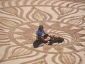 Beautiful sand mandala with its artist named Vitor Raposo