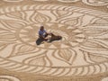 Beautiful sand mandala with its artist named Vitor Raposo