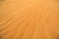 Beautiful sand ripples on the seashore of brown yellow sandy beach. Natural outdoor view backdrop screensaver background concept