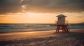 A beautiful sandy beach with evening golden hour sunset, and lifeguard tower, cloudy sky, good for background and backdrops.