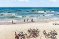 Beautiful sandy beach with a few tourists.Bicycles on the sand.Klaipeda,Lithuania.12-08-2021