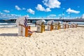 Beautiful sandy beach full of wicker chairs against blue sky Royalty Free Stock Photo