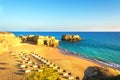 Beautiful sandy beach among rocks and cliffs with sunbeds near Albufeira in Algarve Royalty Free Stock Photo