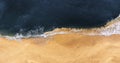 Beautiful sandy beach, top view. Panoramic view of the sandy beach. The sea wave rolls on the shore. Sea coast view from the air. Royalty Free Stock Photo