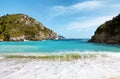 Beautiful sandy beach and waves in a bay at Paleokastritsa Royalty Free Stock Photo