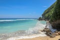 Beautiful sandy beach with white sand and rolling calm wave of turquoise ocean on Sunny day. White clouds in blue sky are Royalty Free Stock Photo