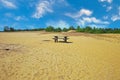 Beautiful sandy dune plateau, isolated rest area with wood bench and table, green forest, blue summer sky - Maasduinen NP, Royalty Free Stock Photo