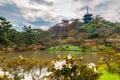 Sankeien garden with Tomyoji former three storied pagoda, flowers and water in Yokohama, autumn background