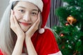 Beautiful Santa Claus woman smile happily,cheerfully and attractive,wearing hat Santa Claus,decorated christmas tree colorful Royalty Free Stock Photo