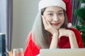 Beautiful Santa Claus woman smile happily,cheerfully and attractive,wearing hat Santa Claus,decorated christmas tree colorful Royalty Free Stock Photo