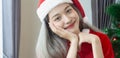 Beautiful Santa Claus woman smile happily,cheerfully and attractive,wearing hat Santa Claus,decorated christmas tree colorful Royalty Free Stock Photo