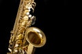 Beautiful saxophone on black background, closeup. Musical instrument