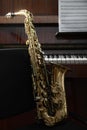 Beautiful saxophone near grand piano. Musical instruments Royalty Free Stock Photo