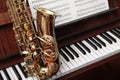Beautiful saxophone on piano. Musical instruments Royalty Free Stock Photo