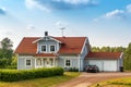 Beautiful scandinavian style house with two places garage and gar in fron of it. Summer with blue scky and green grass Royalty Free Stock Photo