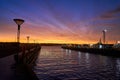 Beautiful scarlet sunset in the port part of the city near the sea