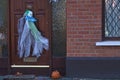 Beautiful and scary Halloween decor on typical Irish house. Halloween 2020 decoration with horror clown on the door