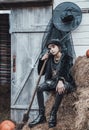 Beautiful scary little girl celebrating halloween. Terrifying black, white half-face makeup and witch costume, stylish image.