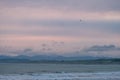 Beautiful scene of the beach with snow mountain at dusk. I Royalty Free Stock Photo