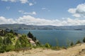 Beautiful scene of colombian countryhouse near to a blue lake in middle of mountain range