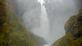 Beautiful scene of Kegon waterfall with mist among colorful autumn trees for background