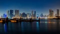 Beautiful scene of a modern city with high skyscrapers and buildings illuminated at night Royalty Free Stock Photo