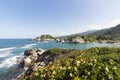 Beautiful scene of rocky tropical jungle mountains and turquoise caribbean sea in golden hour at colombian tayrona park Royalty Free Stock Photo