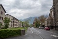 Beautiful scene of street with buildings in Interlaken on mountain and cloudy sky background