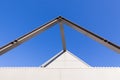 Beautiful scene of Triangular roof frame against Clear blue sky background in town