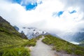 Beautiful scene of walking way and green nature and rocky mountain with glacier over the Mt Cook National park (Muller hut track) Royalty Free Stock Photo