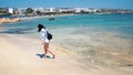 Beautiful scene of a woman walking on ocean beach. Young barefoot girl along the surf line Royalty Free Stock Photo