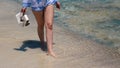 Beautiful scene of a woman walking on ocean beach. Young barefoot girl along the surf line Royalty Free Stock Photo
