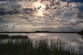 Beautiful scenery of an afternoon wetland view with a Sun Dog under a cloudy sky