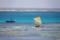 Beautiful scenery of a colorful fishing boat and fisherman sailing on a calm sea under the warm sun of Madagascar