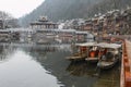 Beautiful scenery early morning view of Fenghuang village, a traditional houses along the river with boats parking in Hunan China