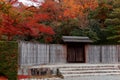 Beautiful scenery of fiery maple trees by the wooden gate & fence at the entrance to the Japanese gardens of Shugakuin Imperial Vi Royalty Free Stock Photo