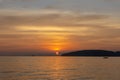 Beautiful scenery of glowing orange light of the evening sunset painted on cloudy sky become to twilight scene above the sea Royalty Free Stock Photo