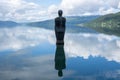 Beautiful scenery of a granite sculpture of a man standing in the harbor of the town