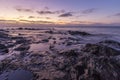 Beautiful scenery of huge rock formations near the sea under the breathtaking sunset sky Royalty Free Stock Photo