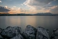 Beautiful scenery of huge rocks near the lake Garda with the reflection of the sunset sky in Italy Royalty Free Stock Photo