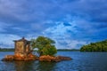 A beautiful scenery of an island with trees bushes and water and cloud. Royalty Free Stock Photo