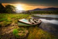 Beautiful scenery of the Killarney lake with boat at sunset in county Kerry, Ireland Royalty Free Stock Photo