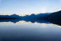 Beautiful scenery of lake McDonald reflecting the sky and mountains in Montana, United States