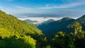 Beautiful scenery landscape of forest and mountain with mist  and blue sky in morning light Royalty Free Stock Photo