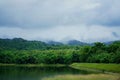 Beautiful scenery of cloud and foggy overcast greenery rain forest mountain with lake landscape at Jedkod-