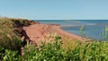 Beautiful scenery of North Cape, PEI, where the sun shines against the red sand beach by the ocean. Royalty Free Stock Photo