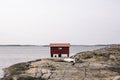 Beautiful scenery of a red cabin  by the sea Royalty Free Stock Photo