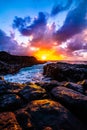 Beautiful scenery of rock formations by the sea at Queens Bath, Kauai, Hawaii at sunset Royalty Free Stock Photo