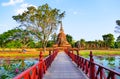 Beautiful Scenery Scenic View A Red Bridge Crossing Traphang-Trakuan Lake to The Ancient Buddhist Temple Ruins of Wat Sa Si in The Royalty Free Stock Photo