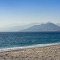 Beautiful scenery of the sea surrounded by the Cretan mountains under the clear sky Royalty Free Stock Photo